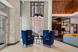 a lobby with blue chairs and a table at Hyatt Place Tampa/Wesley Chapel in Lutz