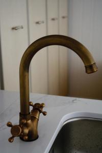 a bronze water faucet on a kitchen sink at 42 Juhkentali in Tallinn