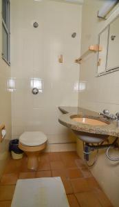 a bathroom with a sink and a toilet at Hotel Indaiá in Maringá