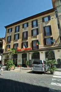 a building with a van parked in front of it at Hotel Genova in La Spezia