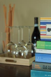 a stack of books sitting on top of a table at La Basiglia Apartment in Monforte dʼAlba