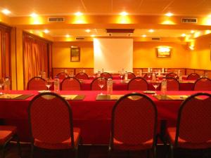 a conference room with red tables and chairs in it at Hotel y Casona El Carmen in Perlora