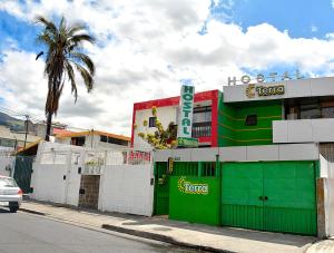 a building with green doors on the side of a street at Hostal Terra 1 - ANDALUCÍA in Quito