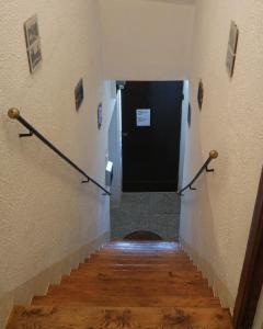 a hallway with a staircase with a black door at Apartman Old Town in Trogir
