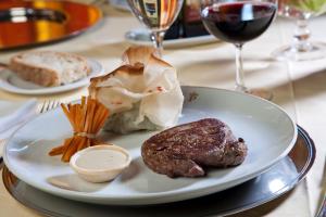 a plate of food with meat and carrots on a table at Parador de Fuente Dé in Fuente Dé