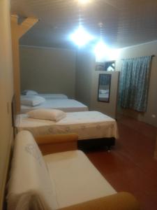 a hotel room with a bed and a lamp at Cumbipar King Hotel in Guarulhos