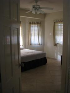 Apartments in Maya's Bajan Villas tesisinde bir odada yatak veya yataklar