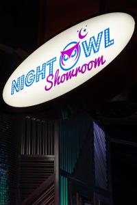 a sign for the night showroom on a surfboard at OYO Hotel and Casino Las Vegas in Las Vegas