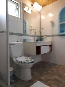 a bathroom with a toilet and a sink and a mirror at 藍白舍 in Yanliau