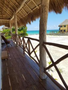 a wooden deck with a view of the beach at Casa Kay in Playa del Carmen