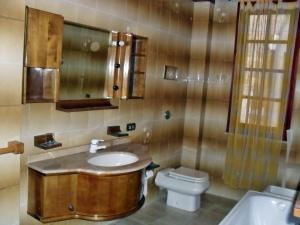 a bathroom with a sink and a toilet at Home Vivaldi in Castellammare del Golfo +27 photos
