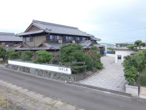 a building with a white bench in front of a street at Minpaku Nagashima room1 / Vacation STAY 1028 in Kuwana