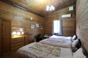 Voodi või voodid majutusasutuse Canadian Village Goryu toas