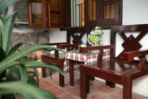 a room with wooden chairs and a vase of flowers at Impressive Boutique Hotel in Hanoi