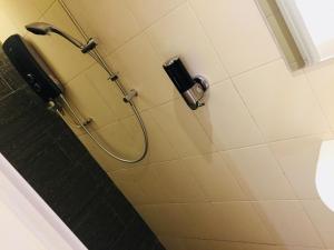a shower with a hose in a bathroom at Sovotel @ Puchong in Puchong