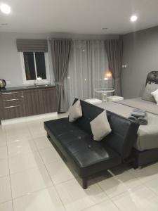 a living room with a bed and a couch at Asia's Beach Apartments in Sattahip