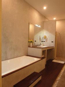 a bathroom with a bath tub and a sink at Chuan Chom Villas in Lamai