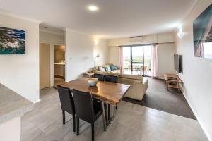 a living room with a table and a couch at Margaret River Beach Apartments in Margaret River Town