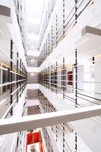 a large warehouse with white shelving and a red stool at Klub Hotel Bangkok in Bangkok