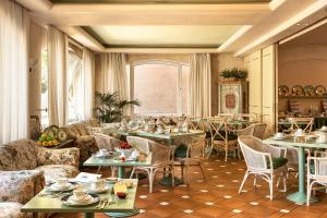 a dining room with tables and chairs and a room with at Albergo Al Moretto in Castelfranco Veneto