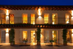 a building with a balcony with chairs and tables at Albergo Al Moretto in Castelfranco Veneto