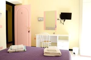 a room with a bed and a desk and a mirror at B&B Sardinia Room Siscaledda in Dorgali