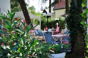 a patio with chairs and a table and a gazebo at Villa Flaming in Sopot