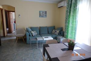 a living room with a blue couch and a table at Princ Gabi in Málaga