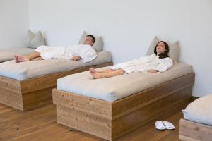 A bed or beds in a room at Salzburg Hotel Holznerwirt