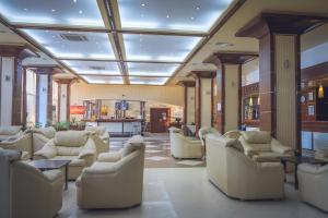 a waiting room with white chairs and tables at ELPIDA Hotel - All Inclusive & Beach Front in Golden Sands