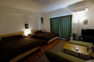 Postel nebo postele na pokoji v ubytování Yomitan Ocean View Apartment 402