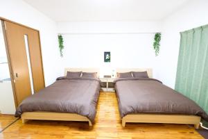 Postel nebo postele na pokoji v ubytování Yomitan Ocean View Apartment 402