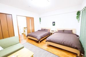 Postel nebo postele na pokoji v ubytování Yomitan Ocean View Apartment 402
