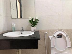 a bathroom with a sink and a toilet and a mirror at Thiên Hải 2 Hotel in Quy Nhon +80 photos