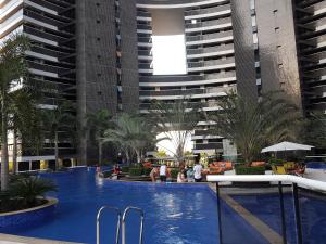 a large swimming pool in a building with tall buildings at Landscape Beira mar in Fortaleza