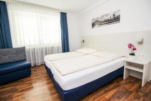 Postel nebo postele na pokoji v ubytování Hotel Olympia