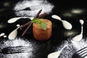 a plate with a piece of food with powdered sugar at Beim Hochfilzer Superior 4 Sterne in Söll