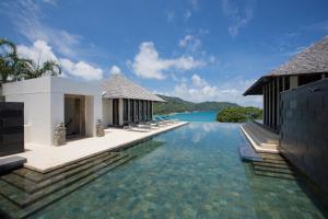 a villa with a swimming pool and a resort at Villa Princess Stephanie in Kata Beach