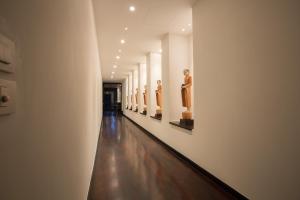 a hallway of a museum with statues on the walls at Villa Princess Stephanie in Kata Beach