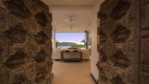 a hallway with a stone wall with a view of the ocean at Villa Princess Stephanie in Kata Beach