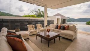 a living room with couches and a coffee table at Villa Princess Stephanie in Kata Beach
