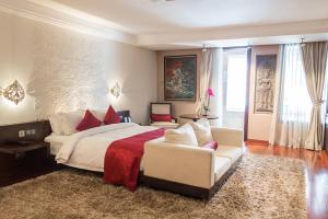 a bedroom with a large bed and a couch at Arunreas Hotel in Phnom Penh +50 photos