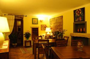 a living room with a table and a dining room at La Casa Di Babbai in Nuchis