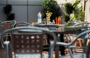 a table with chairs and a bottle of water on it at Odst Jeddah in Jeddah