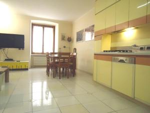 a kitchen and dining room with a table and chairs at MY HOME -centro a Sanremo in Sanremo
