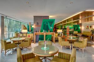 a lobby with tables and chairs in a store at Al Khoory Executive Hotel, Al Wasl in Dubai