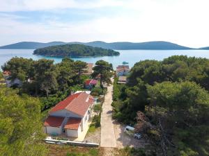 an aerial view of a house next to a body of water at Spacious Holiday Home in Molat with Pool in Brgulje