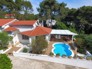 an aerial view of a house with a swimming pool at Spacious Holiday Home in Molat with Pool in Brgulje