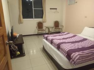 Una cama o camas en una habitación de 內灣星光流域民宿