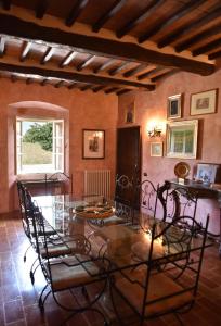 a dining room with a glass table and chairs at B&B da Michela in Perugia